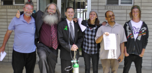 Advocates pose for celebratory picture after submitting petition